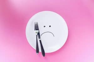 Empty plate with unhappy face