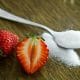 spoonful of sugar next to cut strawberry