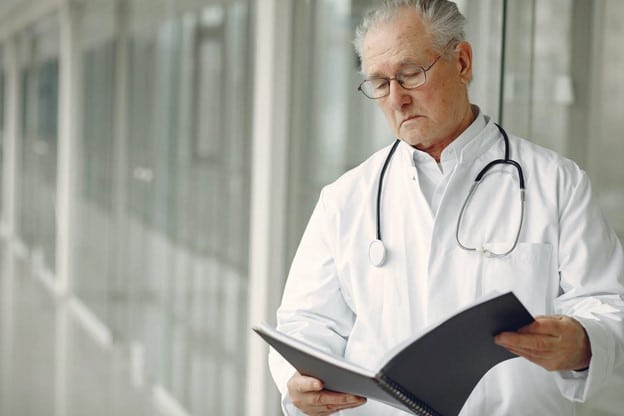 Concerned Doctor looking at medical report about unexplained weight loss